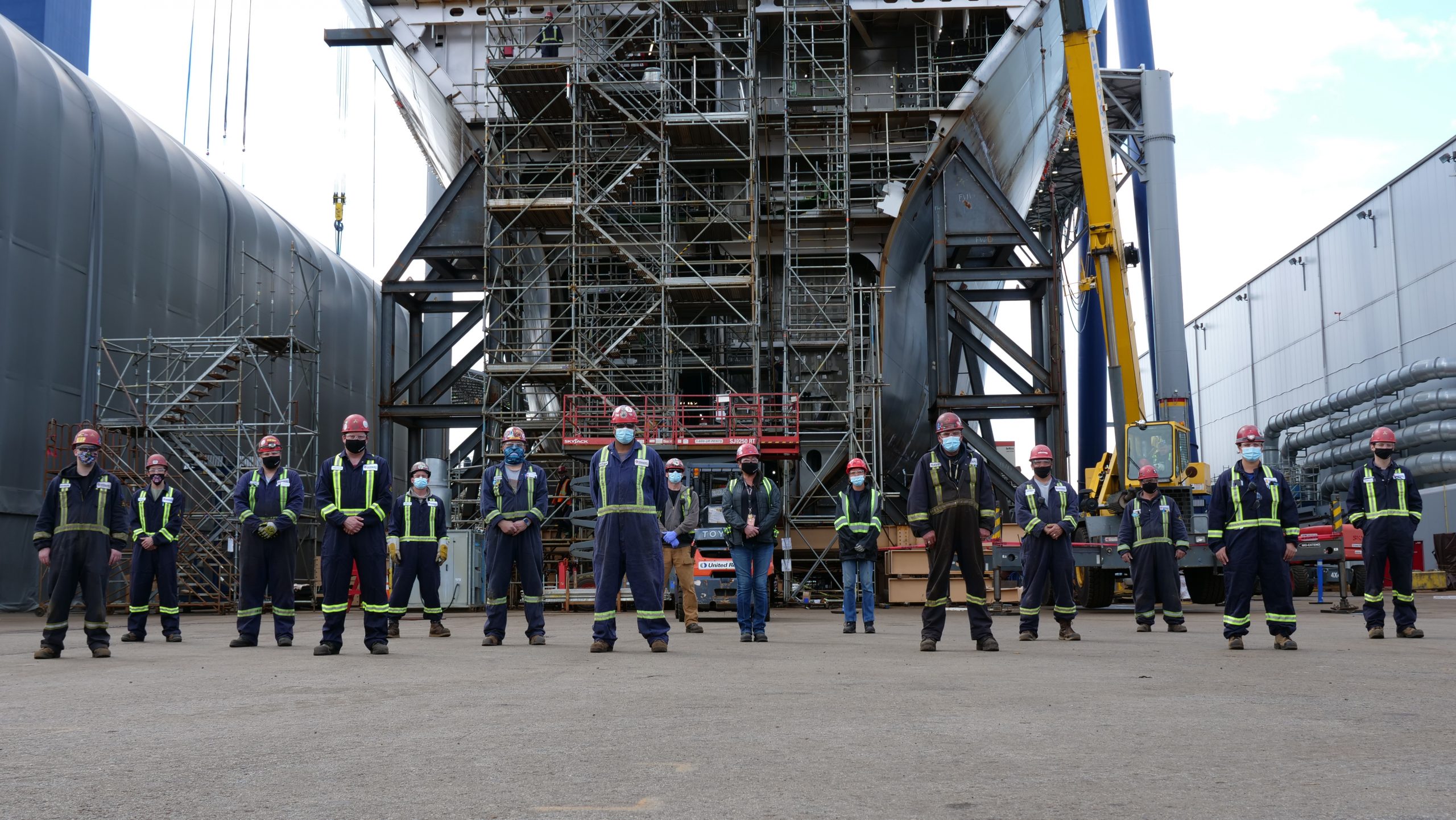 seaspan workers standing in front of JSS hull