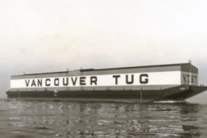 black and white photo of barge with vancouver tug written on side