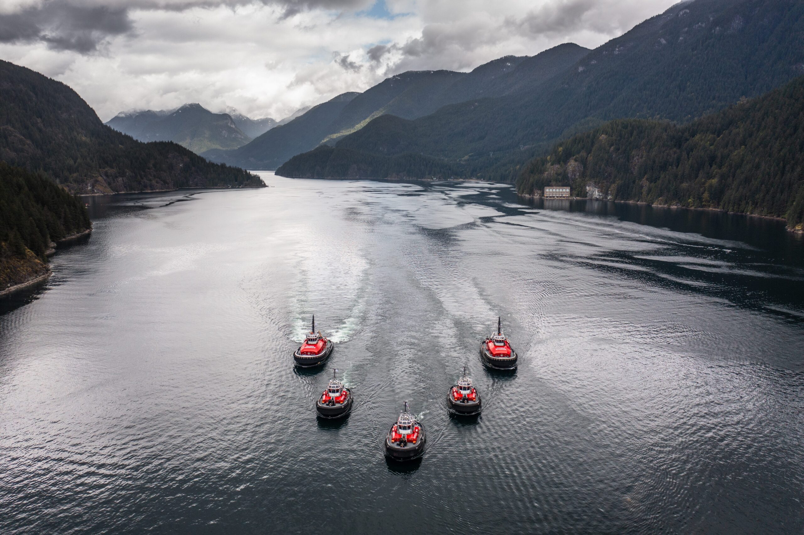 Fleet of tugboats in v formation