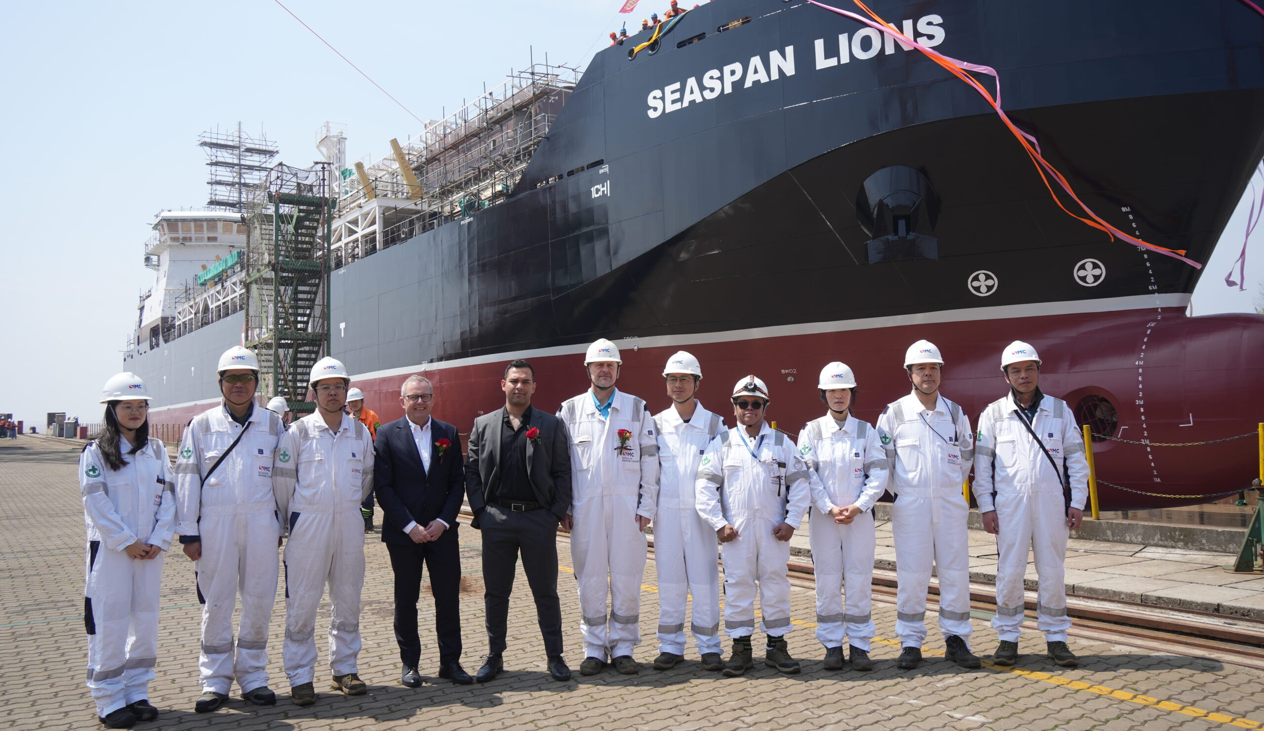 Group of people standing in front of vessel