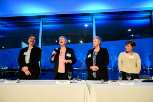 A group of women speaking at an event