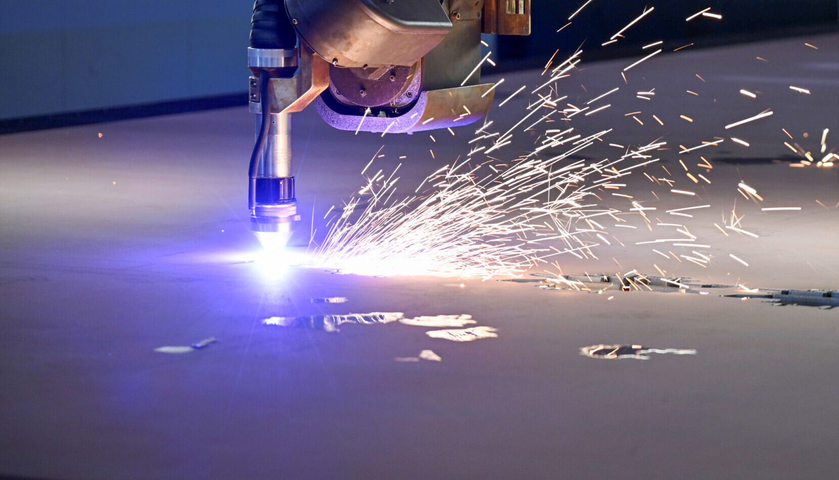 sparks flying on automated steel cutting machine