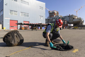 Member of Seaspan's Environment Team checks a stormwater drain system