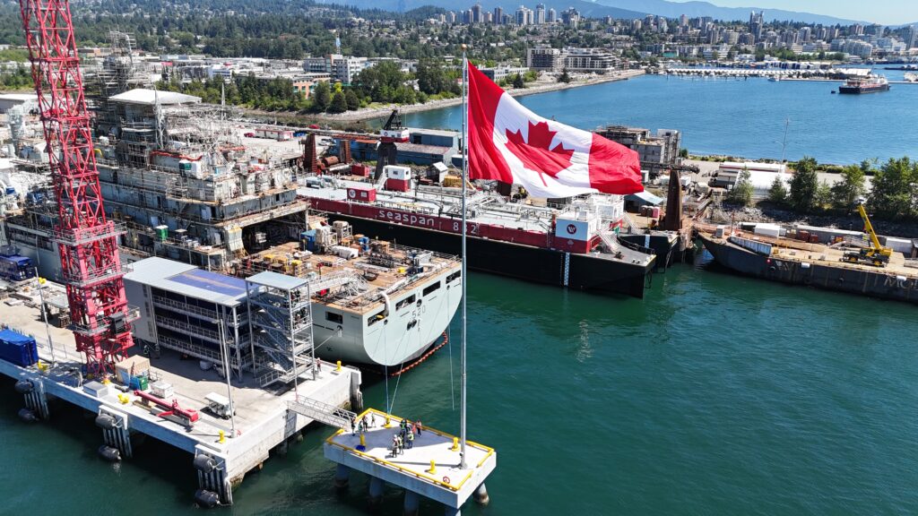 Canada flag in front of navy ship