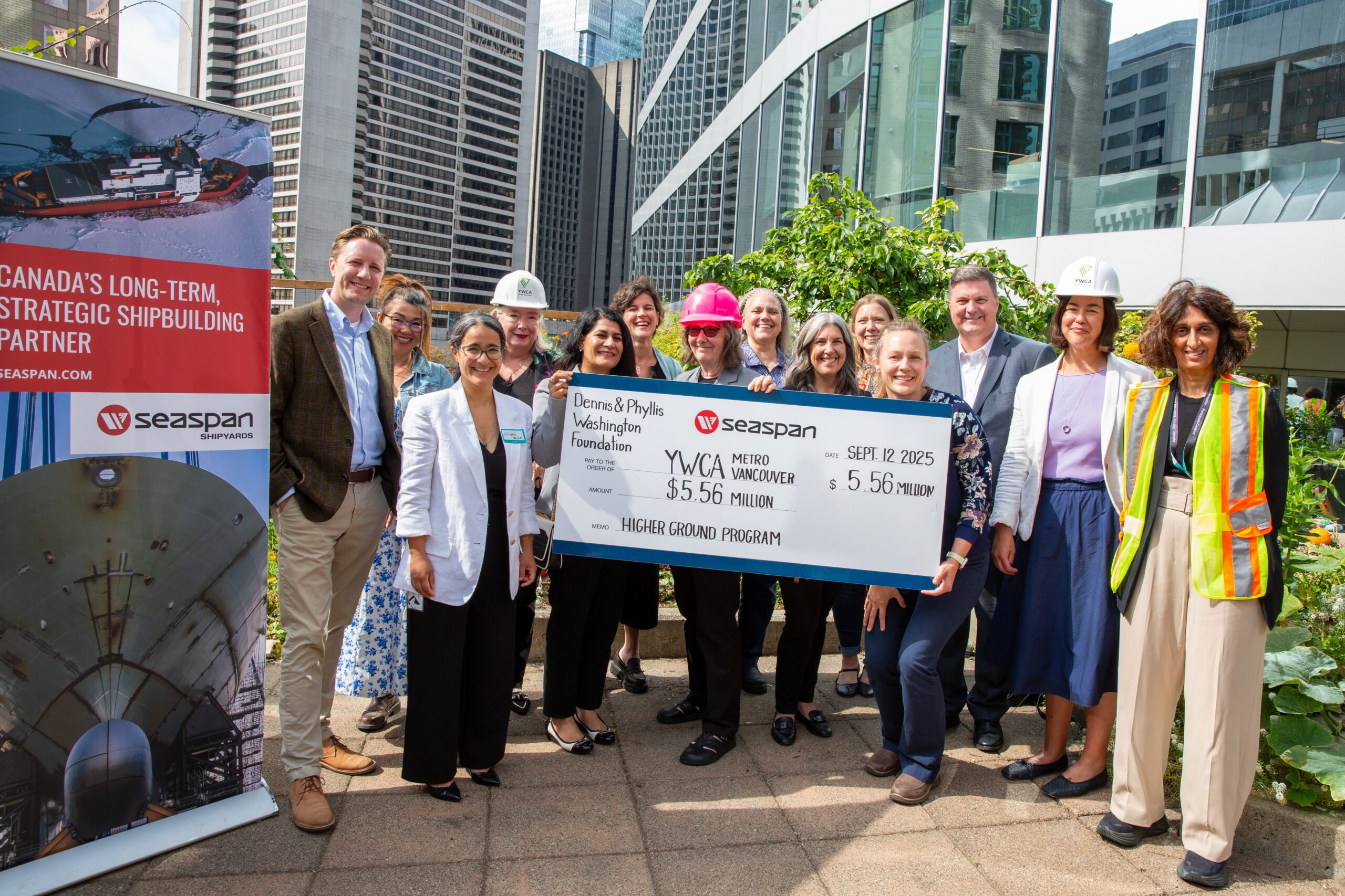 YWCA group holding up large donation cheque