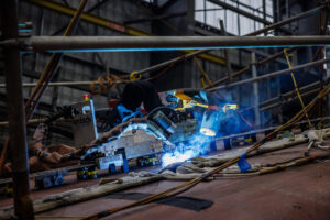 Robotic welding equipment on a steel ship block