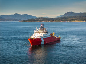 The red and white OOSV vessel in the ocean during sea trials