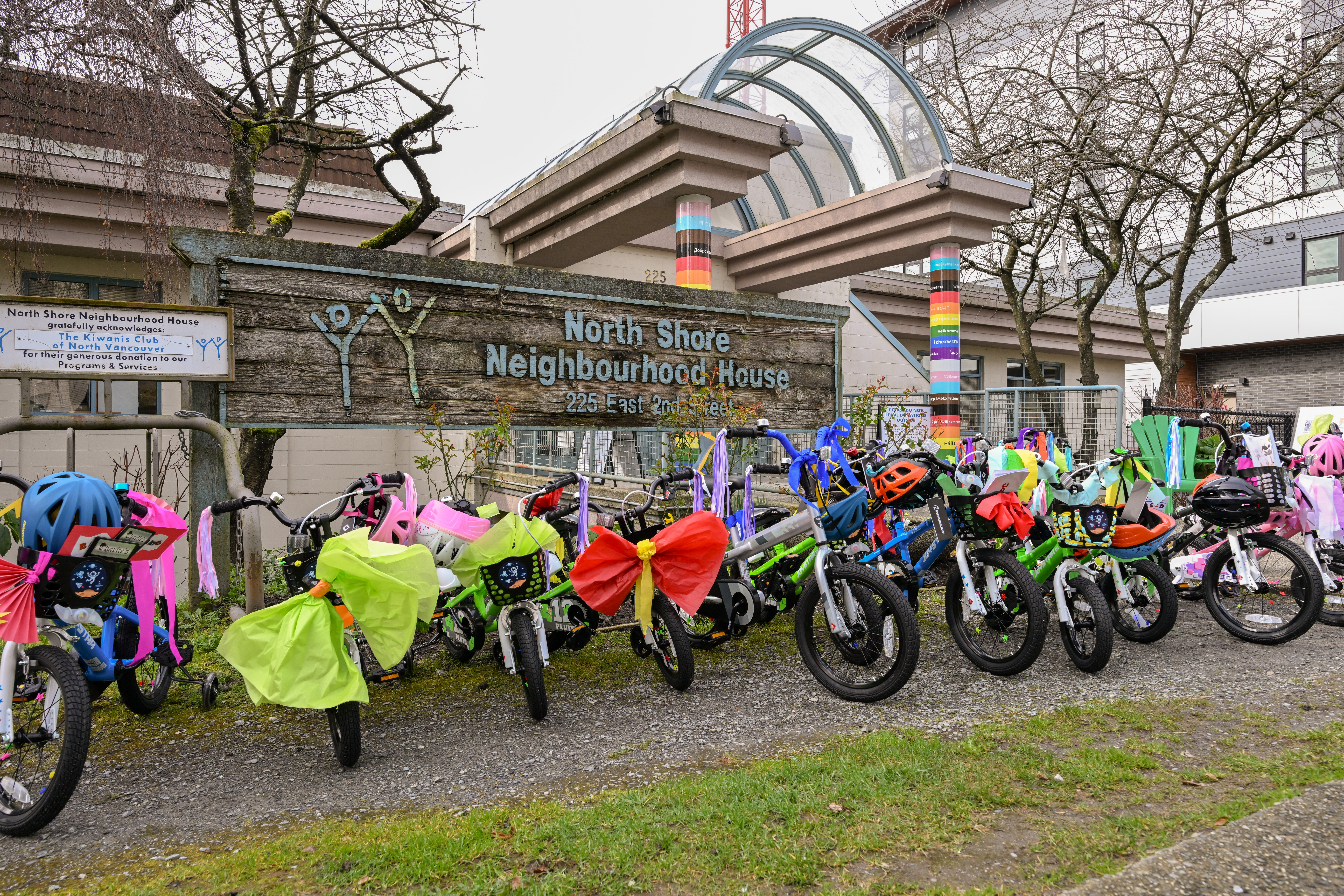 14 decorated bikes in front of the entrance to the North Shore Neighbourhood House