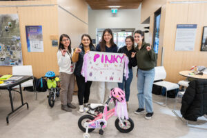 The Pinky team poses together in front of their bike