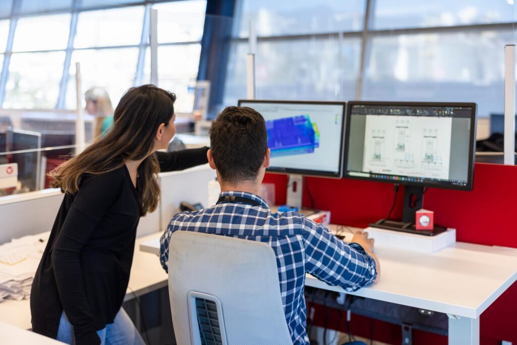 office employees look at engineering diagram
