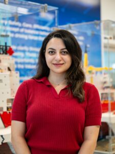 woman in red shirt with black hair in front of a polar icebreaker lego model