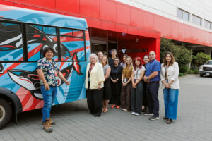 Group photo in front of shuttle bus